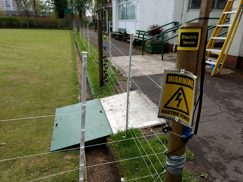 Electric fence around a bowling green. 